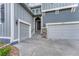 Front exterior with a two-car garage, attractive stonework accents, and well-maintained landscaping at 11821 Discovery Ln, Parker, CO 80138
