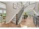 Grand foyer with a soaring staircase, hardwood floors and elegant decor creating an inviting entrance at 11821 Discovery Ln, Parker, CO 80138