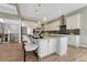 Modern kitchen boasts a large center island with bar seating, stainless appliances, and sleek cabinetry at 11821 Discovery Ln, Parker, CO 80138