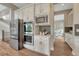 Modern kitchen with stainless steel appliances, gray backsplash, and white cabinets at 11821 Discovery Ln, Parker, CO 80138