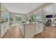Bright kitchen island with seating, granite counters, and stainless steel sink at 11821 Discovery Ln, Parker, CO 80138