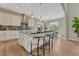 Modern kitchen featuring a large island with seating, sleek countertops, and stainless steel appliances, perfect for cooking and gathering at 11821 Discovery Ln, Parker, CO 80138