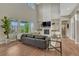 Spacious living room with large windows, tall ceilings, fireplace, and hardwood floors at 11821 Discovery Ln, Parker, CO 80138