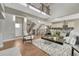Bright living room showcasing an open-concept design, hardwood floors, and staircase at 11821 Discovery Ln, Parker, CO 80138