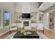 Cozy living room with a stone fireplace, built-in shelving and large windows at 11821 Discovery Ln, Parker, CO 80138