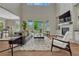 Open-concept living room with high ceilings, large windows, and a modern fireplace at 11821 Discovery Ln, Parker, CO 80138