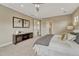 Another view of the bright main bedroom shows neutral colors, ensuite bath and ceiling fan at 11821 Discovery Ln, Parker, CO 80138