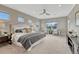 Spacious main bedroom featuring a large bed, sitting area, and ample natural light at 11821 Discovery Ln, Parker, CO 80138