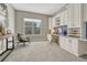 Bright home office featuring custom white built-in cabinets, desk area, chair and neutral decor at 11821 Discovery Ln, Parker, CO 80138