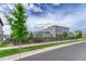 Two-story home with a manicured lawn, trees, and a classic wooden fence at 11821 Discovery Ln, Parker, CO 80138