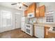 Kitchen with oak cabinets, white appliances, and tile floor at 561 Cherokee St, Denver, CO 80204