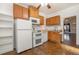 Galley kitchen with oak cabinets and white appliances at 561 Cherokee St, Denver, CO 80204