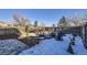 Landscaped backyard with stone patio and fire pit area at 11914 Bellaire Cir, Thornton, CO 80233