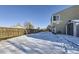 Backyard with snow covered ground and a storage shed at 11914 Bellaire Cir, Thornton, CO 80233