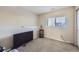 Finished basement room with neutral decor and window at 11914 Bellaire Cir, Thornton, CO 80233