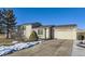 Tan two-story house with attached garage and landscaped yard at 11914 Bellaire Cir, Thornton, CO 80233