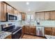 Kitchen with granite countertops and stainless steel appliances at 11914 Bellaire Cir, Thornton, CO 80233