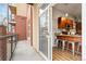 View from the balcony entering a kitchen with wood cabinets and stainless steel stools at 5401 S Park Terrace Ave # 105A, Greenwood Village, CO 80111