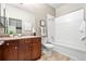 Bathroom with tiled floor, vanity with sink, mirror, toilet, and tub and shower combination at 5401 S Park Terrace Ave # 105A, Greenwood Village, CO 80111