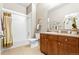 Bathroom features a vanity with storage, toilet, framed mirror, decorative art, and a shower and tub combination at 5401 S Park Terrace Ave # 105A, Greenwood Village, CO 80111