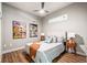 Bedroom offers hardwood floors, a modern ceiling fan, neutral decor, and bedside tables with lamps at 5401 S Park Terrace Ave # 105A, Greenwood Village, CO 80111