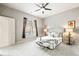 Bright bedroom featuring neutral tones, ceiling fan, and large window for lots of natural light at 5401 S Park Terrace Ave # 105A, Greenwood Village, CO 80111