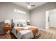 Cozy bedroom showcases hardwood floors, neutral decor, ceiling fan, bedside tables with lamps, and a picture window at 5401 S Park Terrace Ave # 105A, Greenwood Village, CO 80111