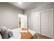 Bedroom features hardwood floors, ceiling fan, large closet with sliding doors, and connecting bathroom at 5401 S Park Terrace Ave # 105A, Greenwood Village, CO 80111