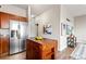 Kitchen with stainless steel refrigerator, hardwood floors and a wood island for extra counter space at 5401 S Park Terrace Ave # 105A, Greenwood Village, CO 80111