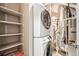 Close up of a stacked washer and dryer, with utilities nearby at 5401 S Park Terrace Ave # 105A, Greenwood Village, CO 80111