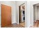 Hallway view of a stacked washer and dryer in an open laundry room at 5401 S Park Terrace Ave # 105A, Greenwood Village, CO 80111