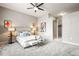 Spacious bedroom with a ceiling fan, neutral decor, a walk-in closet, and plush carpeting at 5401 S Park Terrace Ave # 105A, Greenwood Village, CO 80111