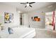 Large main bedroom features a walk-in closet, modern art, ceiling fan, and neutral tones for a relaxing atmosphere at 5401 S Park Terrace Ave # 105A, Greenwood Village, CO 80111