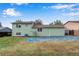 Large backyard with lawn, mature trees, and a shed for outdoor storage at 15628 E Girard Pl, Aurora, CO 80013