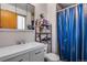 Modern bathroom features updated sink, vanity and a shower with blue curtains at 15628 E Girard Pl, Aurora, CO 80013
