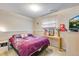 Comfortable bedroom with a window, a decorative bed, and a TV, creating a comfortable and inviting space at 15628 E Girard Pl, Aurora, CO 80013
