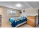 Cozy bedroom features a brightly patterned bedspread and neutral walls at 15628 E Girard Pl, Aurora, CO 80013