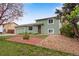Charming home features a well-manicured front yard and green exterior at 15628 E Girard Pl, Aurora, CO 80013