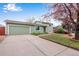 Landscaped front yard of a home with a well-maintained lawn and a garage at 15628 E Girard Pl, Aurora, CO 80013