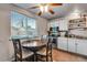Bright eat-in kitchen with stainless steel appliances, ample counter space, and natural light from the window at 15628 E Girard Pl, Aurora, CO 80013