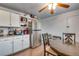 Well-lit eat-in kitchen with appliances, granite counters, and ceiling fan, creating a pleasant dining area at 15628 E Girard Pl, Aurora, CO 80013