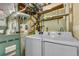 Laundry area with washer, dryer, utility sink, and ample storage space at 15628 E Girard Pl, Aurora, CO 80013