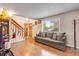 Spacious living room with a large window, comfortable sofa, and elegant decor for relaxing and entertaining at 15628 E Girard Pl, Aurora, CO 80013