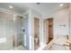 Bright bathroom featuring a glass-enclosed shower, toilet, and double vanity with modern fixtures at 21292 E 63Rd Dr, Aurora, CO 80019