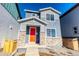 Charming two-story home with a bright red front door and stone accents at 21292 E 63Rd Dr, Aurora, CO 80019