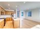 Kitchen with stainless steel appliances, a center island, and an adjacent living area at 21292 E 63Rd Dr, Aurora, CO 80019