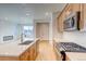 Well-appointed kitchen featuring a large island with ample counter space and modern appliances at 21292 E 63Rd Dr, Aurora, CO 80019
