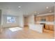 Open-concept living space combines the kitchen and living room with plenty of natural light at 21292 E 63Rd Dr, Aurora, CO 80019