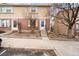 Charming brick and siding townhome with inviting front entrance and well-maintained landscaping at 1545 S Ouray Cir # A, Aurora, CO 80017