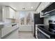 Modern kitchen featuring white cabinets, stainless steel appliances, and plenty of natural light at 1545 S Ouray Cir # A, Aurora, CO 80017